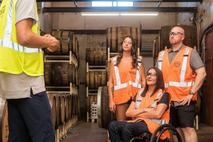 Man Giving a Tour of a Brewery