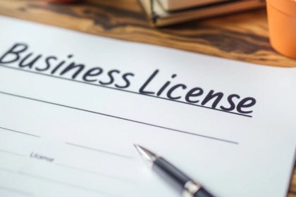 Business license document on a desk with a pen.