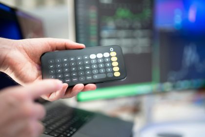 a person holding a remote control in their hand