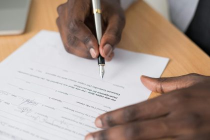 Close-up Photography of Person Writing on White Paper