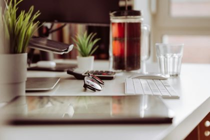 a laptop computer sitting on top of a white desk