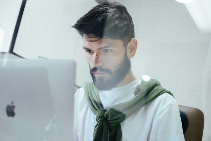 man facing MacBook Pro