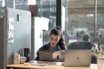 a woman sitting at a table with a laptop