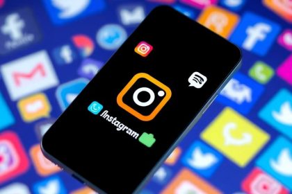 Smartphone with Instagram logo and social media icons.