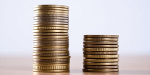 Two stacks of coins, one larger and one smaller.