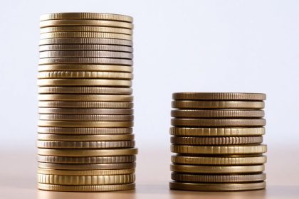 Two stacks of coins, one larger and one smaller.