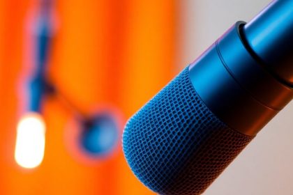 Close-up of a microphone in a cozy studio setting.